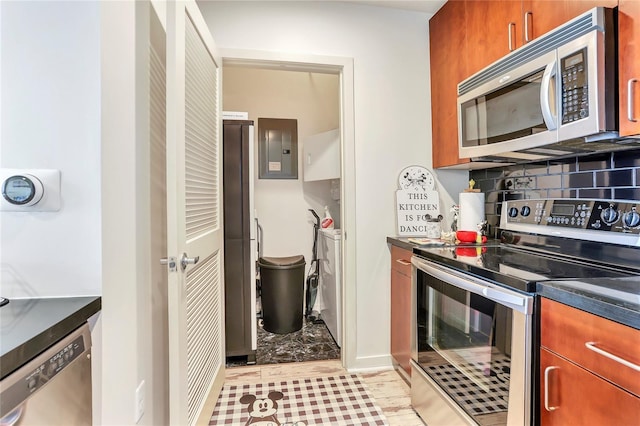 kitchen with decorative backsplash, electric panel, and appliances with stainless steel finishes