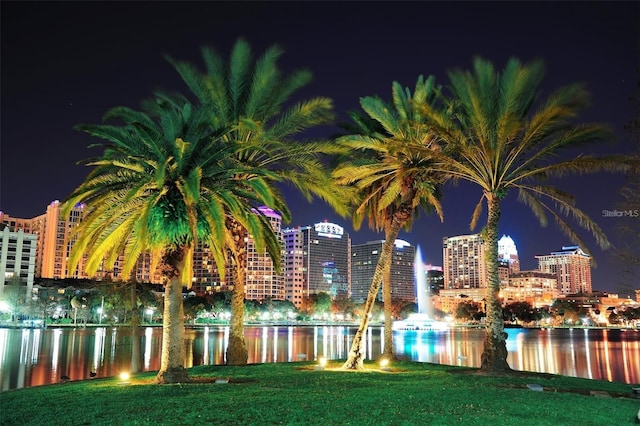 view of property's community featuring a water view and a yard