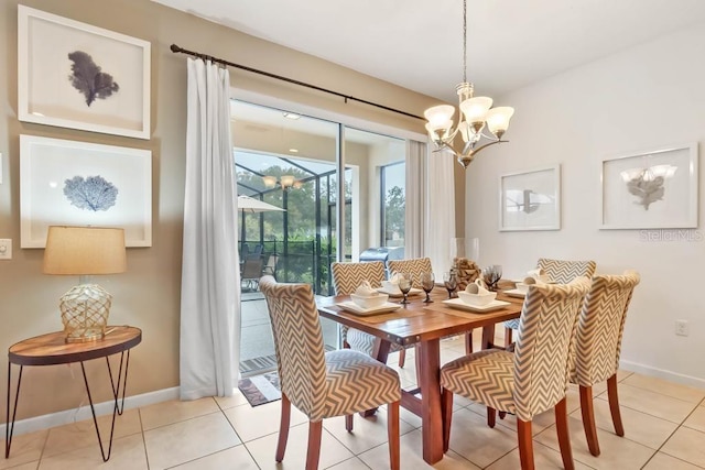 dining room with light tile patterned flooring and a chandelier