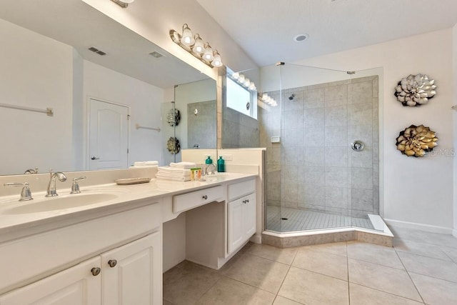 bathroom with tile patterned floors, a shower with door, and double sink vanity