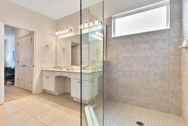 5220 Oakbourne Ave, Davenport, FL 33837 - ensuite bathroom with double vanity, tiled shower, and tile patterned floors