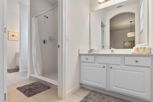 bathroom with vanity, tile patterned floors, and walk in shower