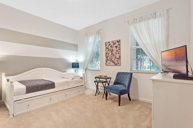 bedroom featuring light colored carpet