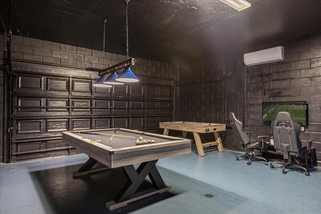 game room with an AC wall unit, concrete flooring, and billiards