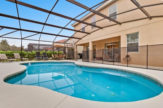 view of swimming pool with glass enclosure