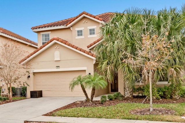 5220 Oakbourne Ave, Davenport, FL 33837 - mediterranean / spanish-style home with driveway, a tiled roof, stucco siding, and a garage