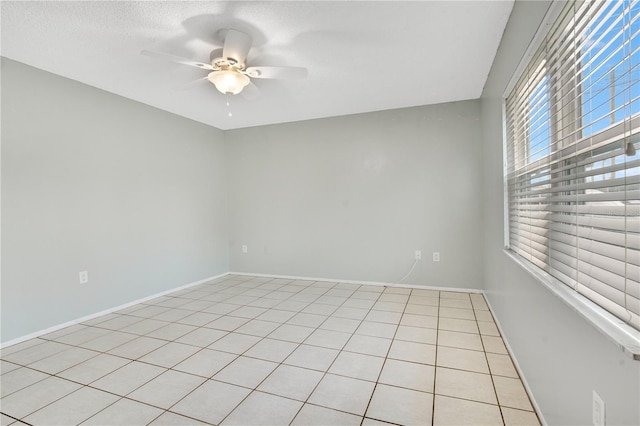 tiled empty room with ceiling fan