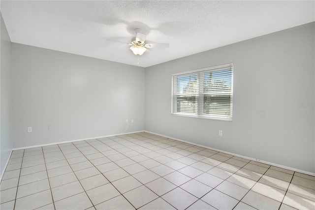 tiled empty room featuring a textured ceiling and ceiling fan