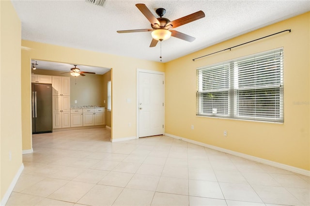 unfurnished room with a textured ceiling