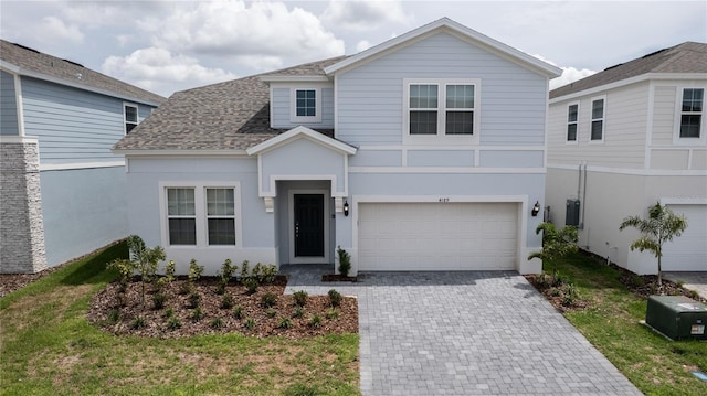 view of front property with a garage and a front lawn