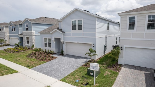 view of front of house with a garage and a front yard