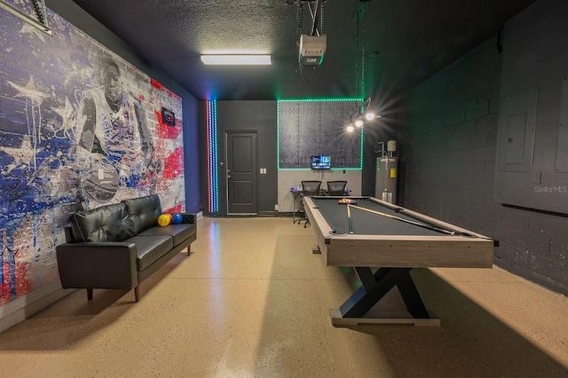 4189 Lana Ave, Davenport, FL 33897 - recreation room with concrete block wall, electric panel, water heater, pool table, and a textured ceiling