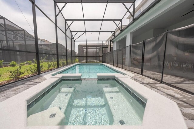 4189 Lana Ave, Davenport, FL 33897 - view of swimming pool with a patio area, glass enclosure, and a pool with connected hot tub