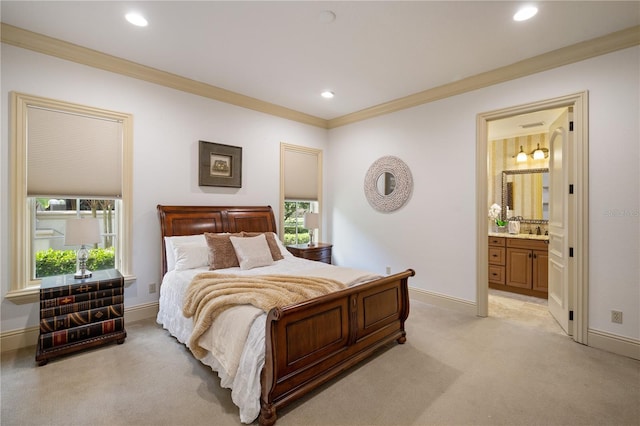 carpeted bedroom featuring sink, crown molding, and ensuite bath