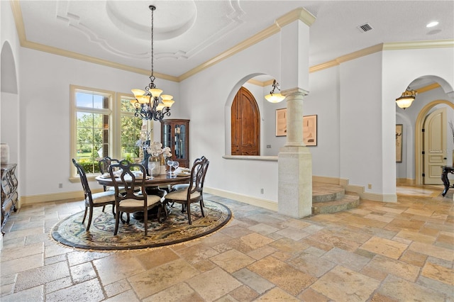 dining room featuring decorative columns, ornamental molding, and an inviting chandelier