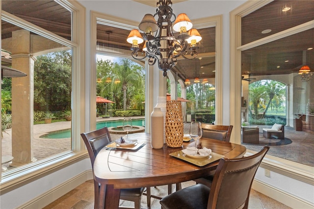 sunroom featuring a notable chandelier