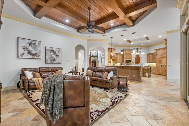 living room with crown molding, beamed ceiling, wooden ceiling, and ceiling fan