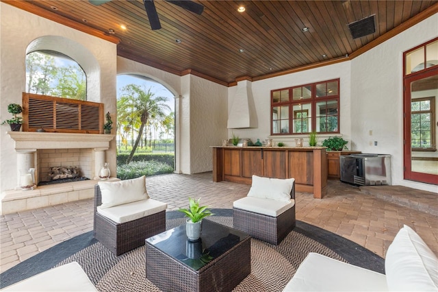 view of patio with exterior fireplace and ceiling fan