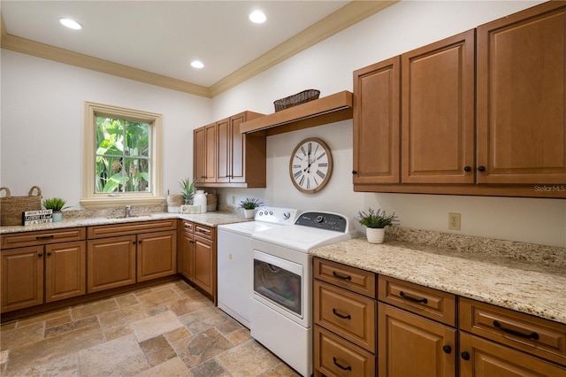 laundry room with cabinets, washer and clothes dryer, ornamental molding, and sink