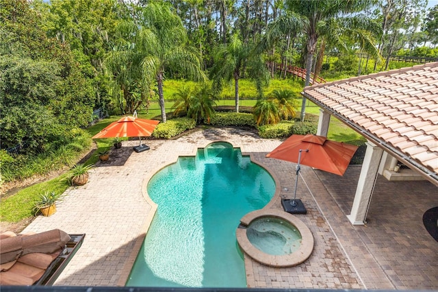 view of swimming pool with an in ground hot tub and a patio