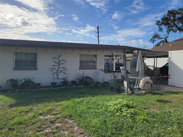 back of property with a yard