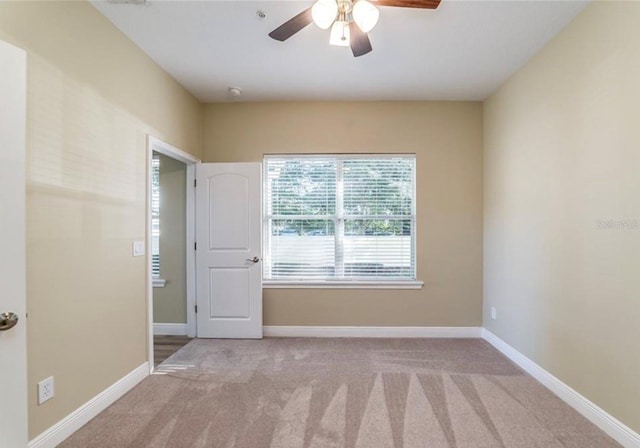 unfurnished room featuring ceiling fan and light colored carpet