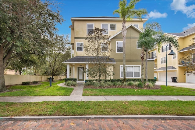 view of front of house with a garage and a front lawn