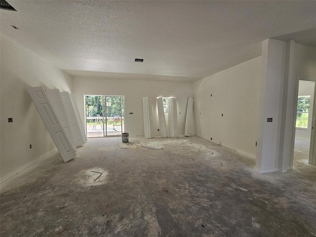 unfurnished living room with a textured ceiling