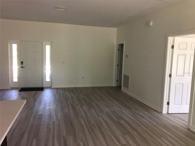 7539 Bernal Dr, Sebring, FL 33872 - foyer with dark wood-style flooring and baseboards