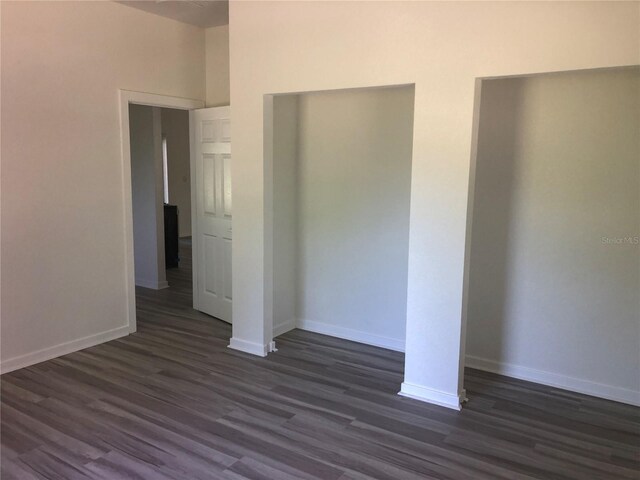 7539 Bernal Dr, Sebring, FL 33872 - unfurnished bedroom with dark wood-style floors and baseboards