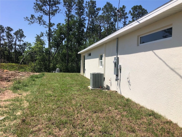 7539 Bernal Dr, Sebring, FL 33872 - view of grassy yard featuring central AC unit