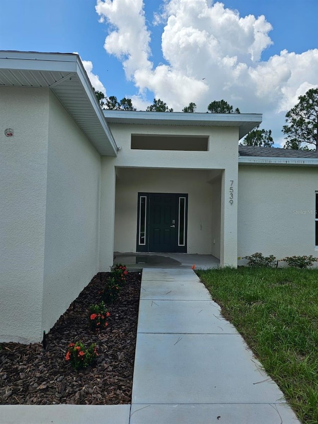 7539 Bernal Dr, Sebring, FL 33872 - view of exterior entry with stucco siding