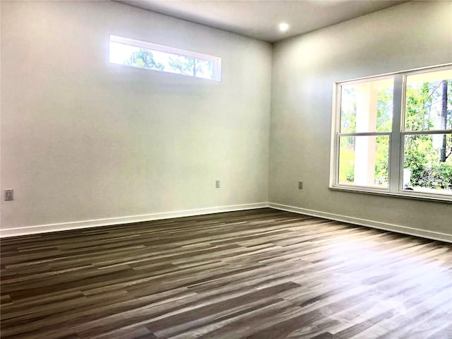 7539 Bernal Dr, Sebring, FL 33872 - empty room with dark wood-style flooring, baseboards, and recessed lighting