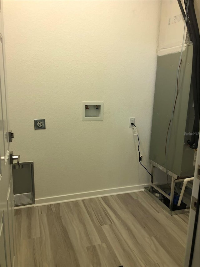 7539 Bernal Dr, Sebring, FL 33872 - laundry room featuring electric dryer hookup, wood finished floors, baseboards, and hookup for a washing machine