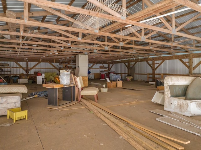 miscellaneous room with lofted ceiling and metal wall