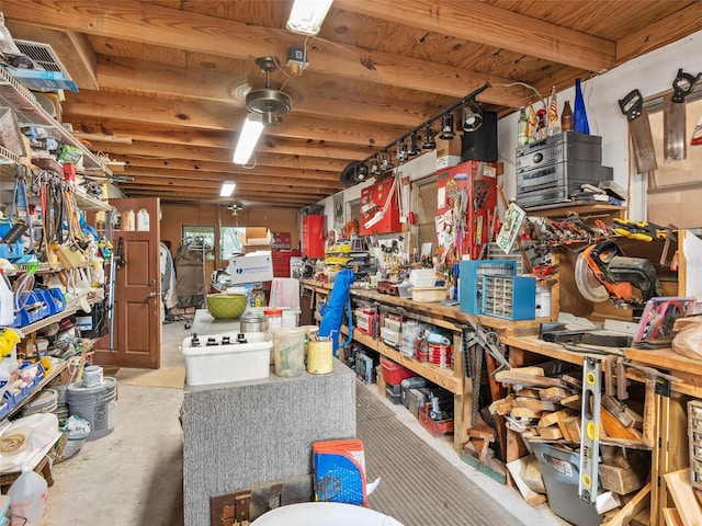 miscellaneous room featuring concrete floors, visible vents, and a workshop area