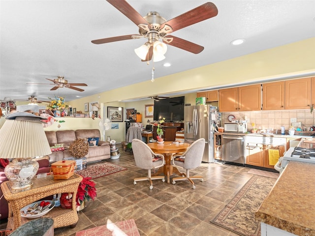 tiled dining area with ceiling fan