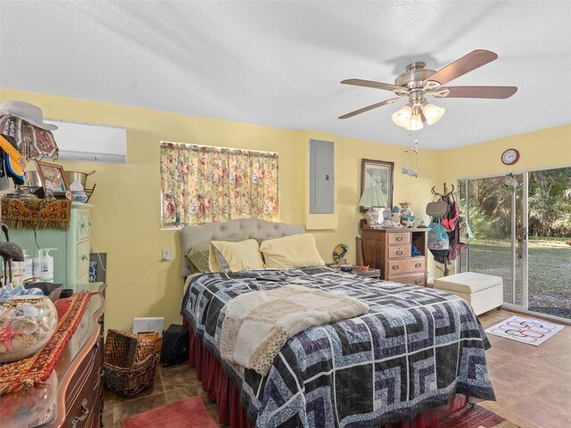 tiled bedroom featuring access to exterior, electric panel, and ceiling fan