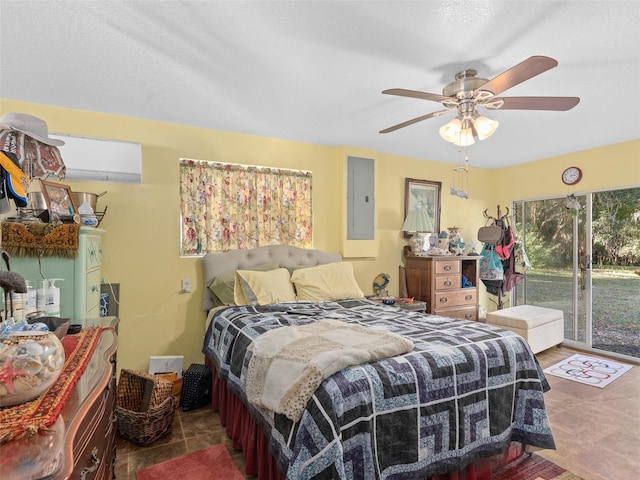 bedroom featuring a ceiling fan, access to outside, electric panel, and a wall mounted AC