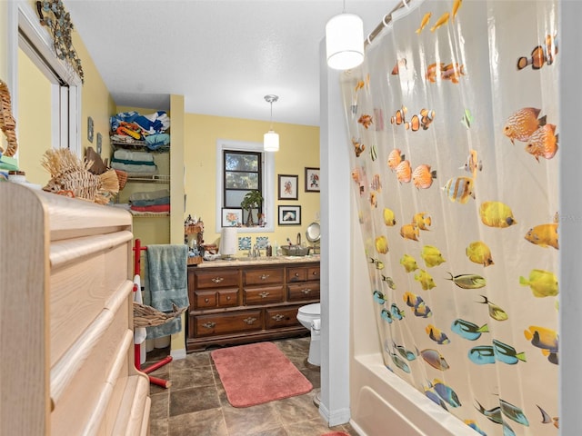 full bathroom with a textured ceiling, toilet, shower / bath combination with curtain, tile patterned floors, and vanity