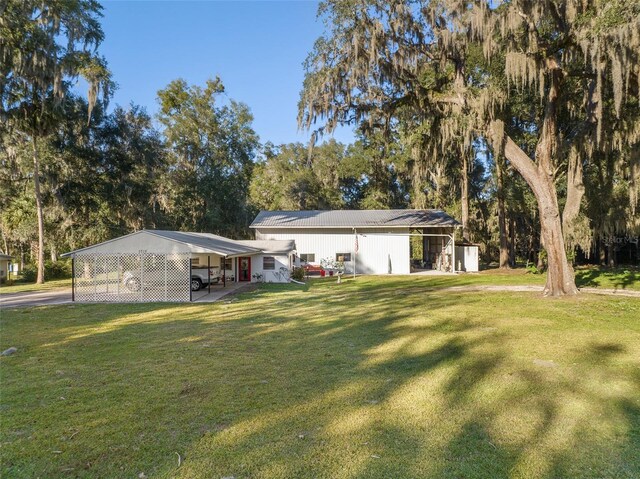 view of yard with a carport and an outdoor structure