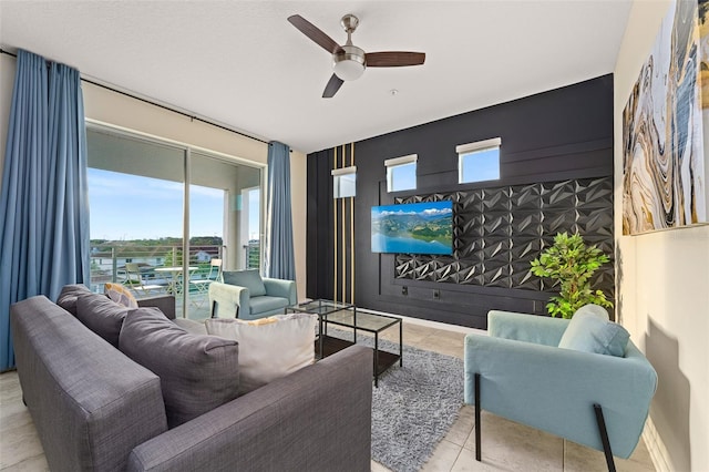 living area featuring a ceiling fan and light tile patterned flooring