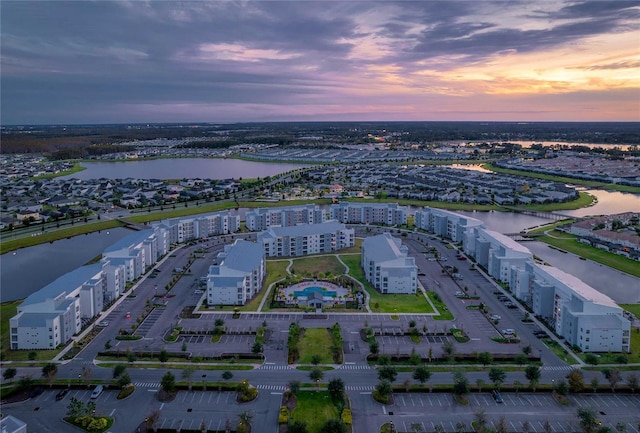 aerial view at dusk with a water view