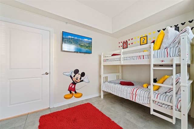 tiled bedroom featuring baseboards