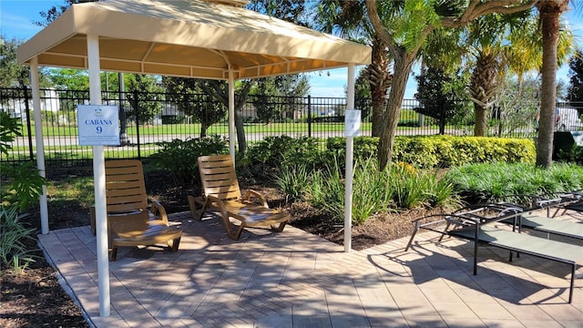 view of patio / terrace with fence and a gazebo