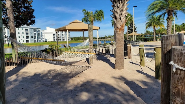 view of jungle gym featuring a water view and a gazebo