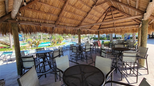 view of patio featuring a gazebo and a community pool