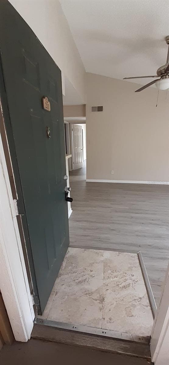 interior space with lofted ceiling and hardwood / wood-style flooring