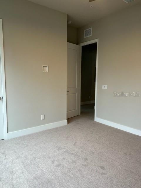 spare room with light colored carpet