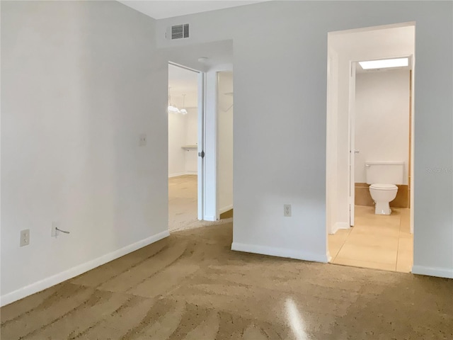 unfurnished bedroom featuring ensuite bathroom